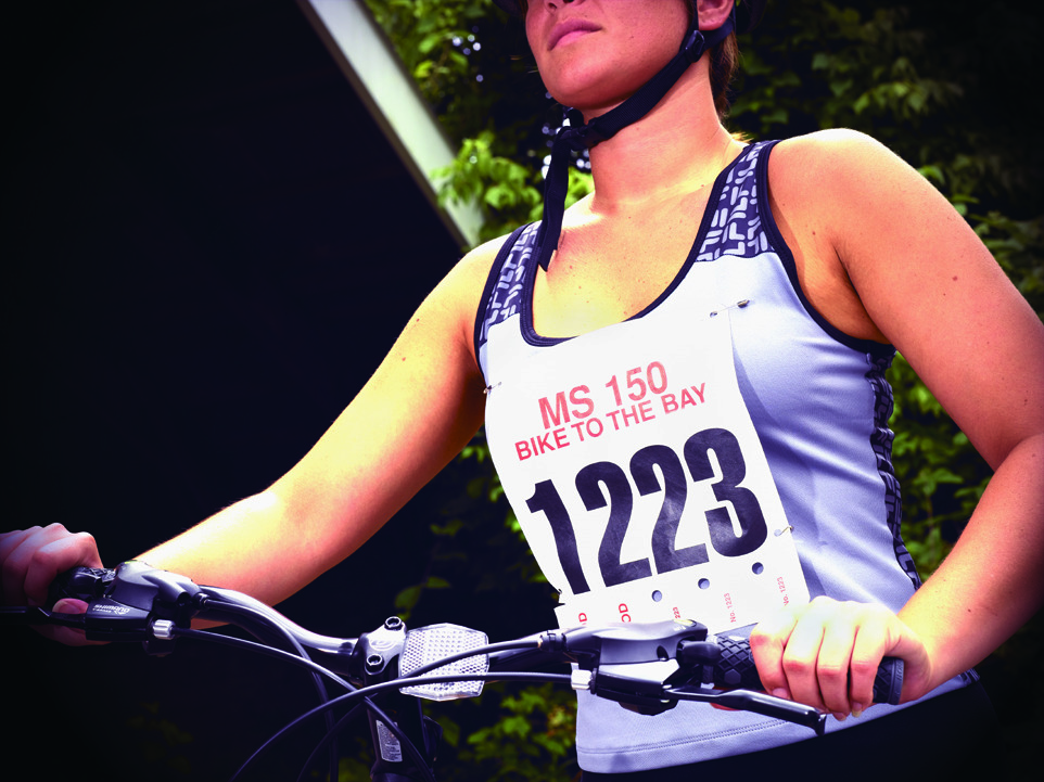A runner wearing a Tyvek race number bib.