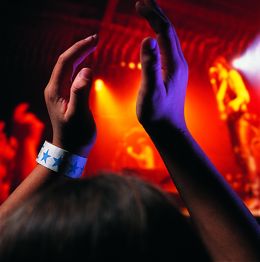 A person wearing a Tyvek wristband at an event.